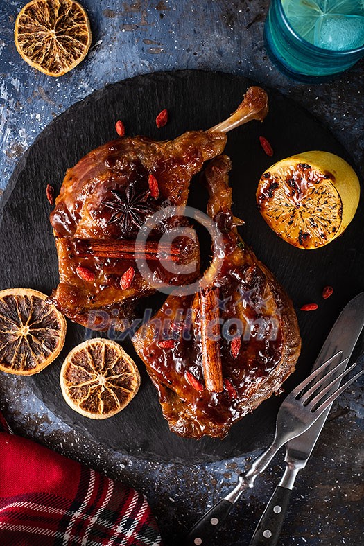 Duck leg confit with rice and goji berries. Traditional french cuisine. View from above.