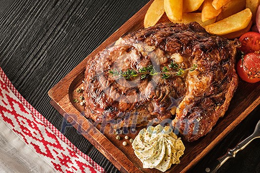 Ribeye steak with potatoes, onions and baked cherry tomatoes. Juicy steak with flavored butter. Ribeye steak with potatoes, onions and baked cherry tomatoes. Juicy steak with flavored butter.