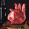 Raw beef meat on a wooden table close up on a dark background