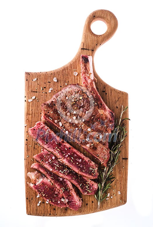 Entrecote. Steak on the bone. Rib eye. Tomahawk steak on the on a cutting board with rosemary. Roasting - Rare. Entrecote. Steak on the bone. Rib eye. Tomahawk steak on the on a cutting board with rosemary. Roasting - Rare.