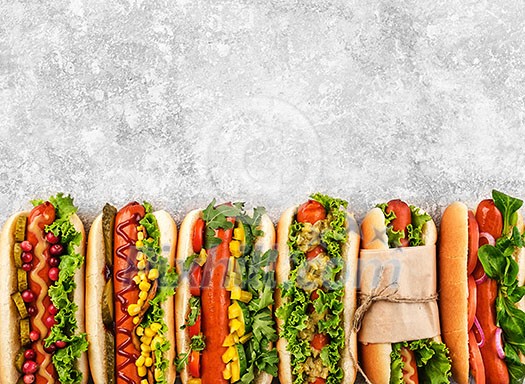 Six different hot dogs on a gray table, top view. Copyspace Six different hot dogs on a gray table, top view. Copyspace