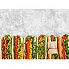 Six different hot dogs on a gray table, top view. Copyspace