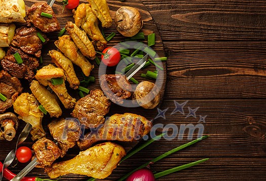 Chicken and beef skewers on a wooden table with tomatoes and green onions. Juicy delicious barbecue picnic. Copyspace Chicken and beef skewers on a wooden table with tomatoes and green onions. Juicy delicious barbecue picnic. Copyspace
