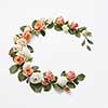 Decoration in the form of corner wreath from beautiful roses flowers with green leaves on a light grey background, copy space. Congratulation card for birthday.
