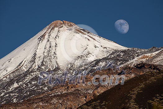 Colorful scenic landscape of moon rise in Tenerife national park of Teide. El Teide with moon rising by its side.