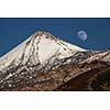 Colorful scenic landscape of moon rise in Tenerife national park of Teide. El Teide with moon rising by its side.