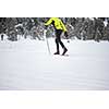 Cross-country skiing: young man cross-country skiing on a winter day