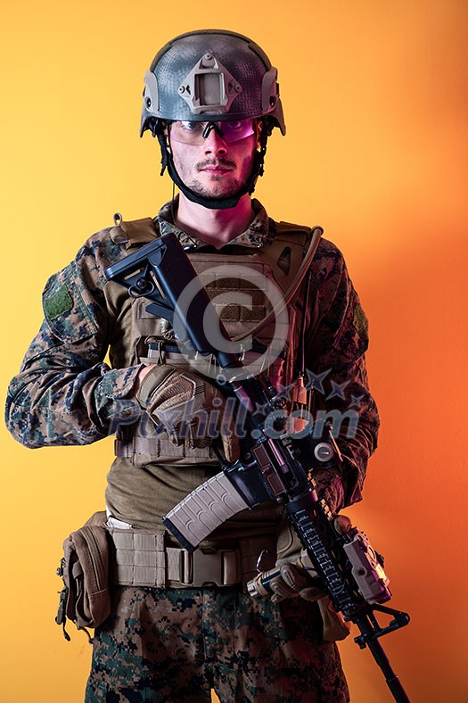 modern warfare marine soldier with fire arm weapon and protective army tactical gear clothes Studio shot isolated on yellow background modern warfare marine soldier with fire arm weapon and protective army tactical gear clothes Studio shot isolated on yellow background