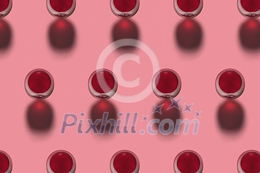 Rows with glasses of red wine alcohol drink on a pink background with hard shadows. Top view. Alcohol drink pattern.