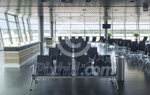 Modern airport terminal with empty arm-chairs for waiting departure. Travel and transportation concept. Modern airport terminal with empty arm-chairs for waiting departure. Travel and transportation concept.