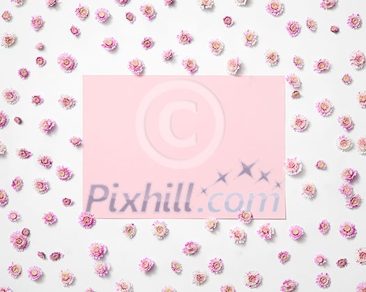 Greeting photo frame from blossoming small flowers and pastel pink rectangular place for text. Flat lay. Valentine's Day concept.
