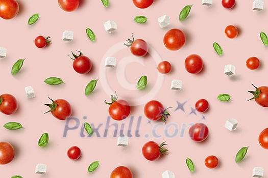 Fresh natural pizza infredients - ripe healthy natural tomatoes, cheese and basil leaves on a light pink background. Top view.