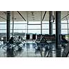 Empty hall at airport with comfortable chairs for waiting departure. Travel and transportation concept.