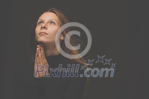Young woman praying to God. Christian life crisis prayer to god. Young woman praying to God. Christian life crisis prayer to god.