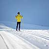 Cross-country skiing: young man cross-country skiing on a winter day