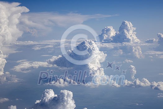 Bright clear blue sky covered white fluffy cumulus clouds in a summer sunny day with copy space. Travel and tourism concept.