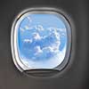 Lighted cloudy clear sky view through aircraft window with copy space. Travel and transportation concept.
