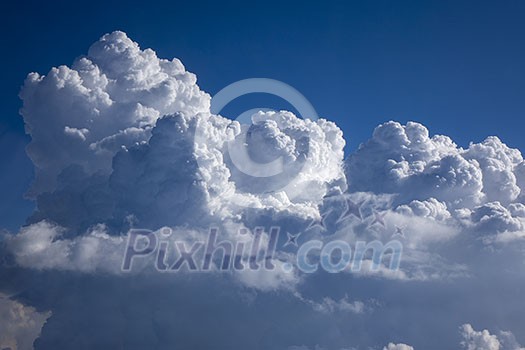 Blue heaven with big cumulus clouds lighted bright sunny beams on a blue clear sky background, copy space. Travel and tourism concept. Blue heaven with big cumulus clouds lighted bright sunny beams on a blue clear sky background, copy space. Travel and tourism concept.