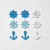 Ship anchors and wheel different colors pattern on a light grey background with hard shadows, copy space. Flat lay