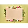 Fresh natural organic flower frame with paper congratulation card on a light olive background with copy space. Valentine's greeting card.