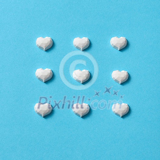 Holiday pattern from plaster white hearts on a pastel blue background with soft shadows. Valentine's day greeting card. Holiday pattern from plaster white hearts on a pastel blue background with soft shadows. Valentine's day greeting card.