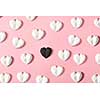 Horizontal holiday pattern from plaster white hearts and one is black on a pastel pink background with soft shadows. Valentine's day greeting card.