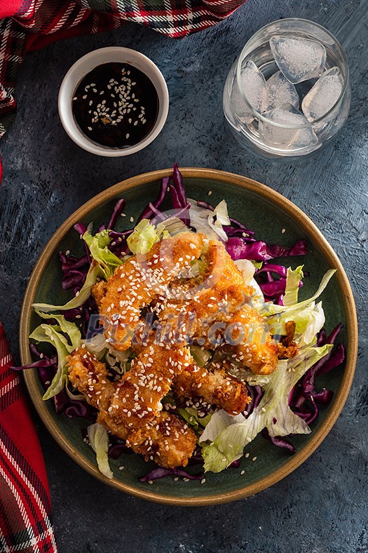 Salad with warm glazing chicken, sprinkled with sesame seeds. Chinese cuisine. Asian culture. Salad with warm glazing chicken, sprinkled with sesame seeds. Chinese cuisine. Asian culture.