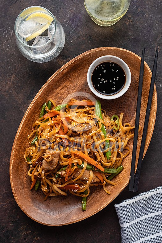 Asian noodles with pork in teriyaki sauce, with green beans, carrots and shiitake mushrooms. Top view.