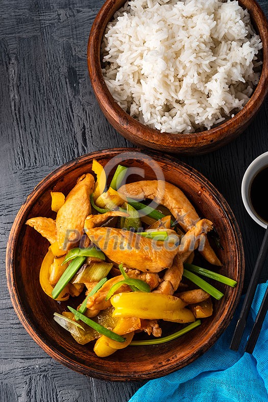 Kung Pao chicken, stir-fried Chinese sichuan traditional sichuan dish with chicken, peanuts, vegetables, rice and chili peppers. Kung Pao chicken, stir-fried Chinese sichuan traditional sichuan dish with chicken, peanuts, vegetables, rice and chili peppers.