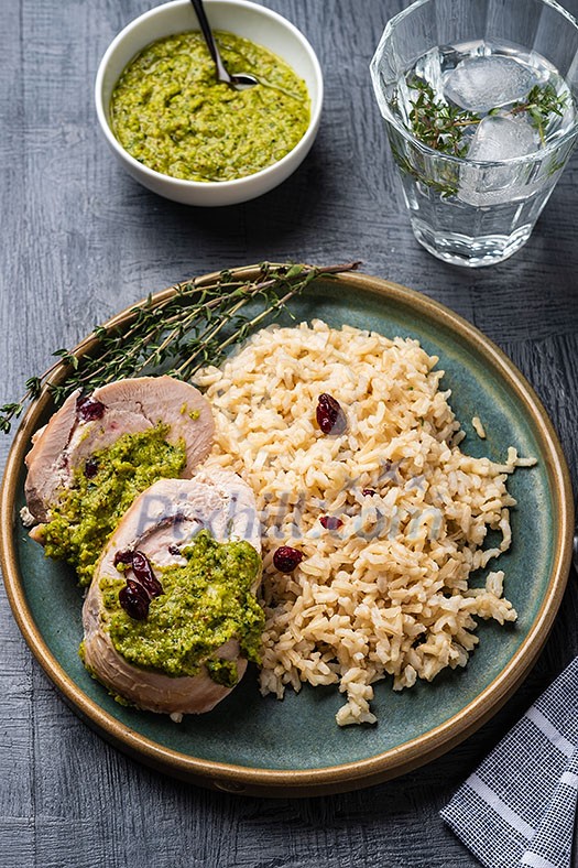 Sliced Chicken Roll with Cranberries, Pesto and Rice. Top view. Sliced Chicken Roll with Cranberries, Pesto and Rice. Top view.