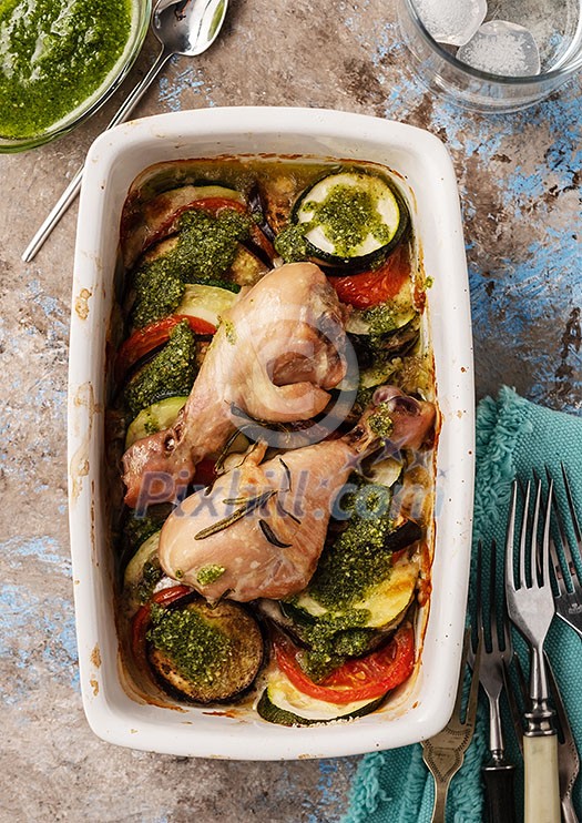Ratatouille with chicken and pesto. French cuisine. Rosemary chicken with oven-roasted ratatouille. Top view.