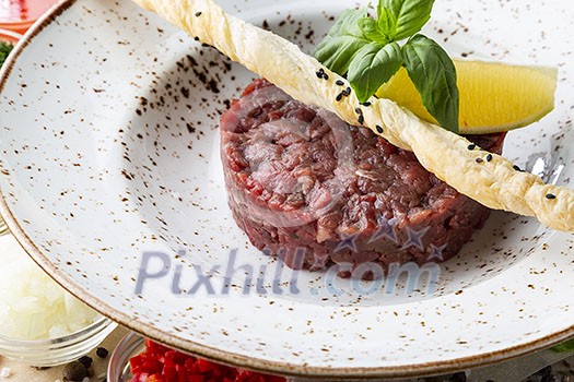 Fresh tasty beef tartare. Minced meat with ingredients for tartar. Fresh tasty beef tartare. Minced meat with ingredients for tartar.