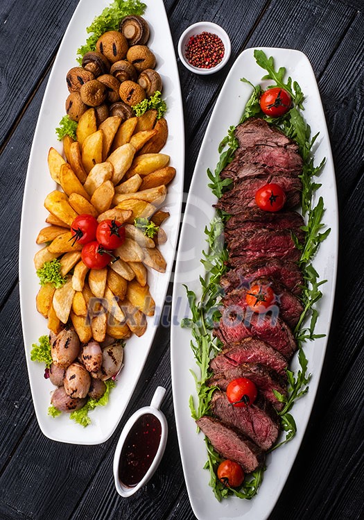 Chateaubriand steak. Served with fried potatoes, champignons, cherry tomatoes and Spanish sauce.