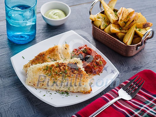 Fried fish with tomato-olive sauce and potatoes Fried fish with tomato-olive sauce and potatoes
