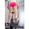 Young woman's muscular legs on stepper/treadmill, closeup