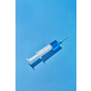 Blue serum or vaccine in plastic syringe 20 ml for an intravenous injection on a pastel blue background with hard shadow, copy space.