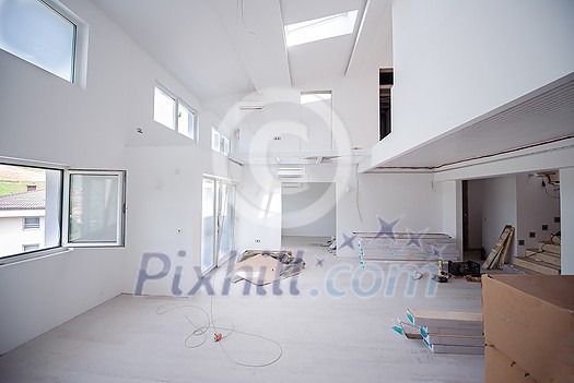 Interior of unfinished stylish modern open space two level apartment with white walls soon ready to move in Interior of unfinished stylish modern open space two level apartment with white walls soon ready to move in