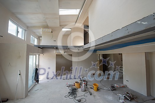 interior of construction site with scaffolding in a large modern unfinished duplex apartment