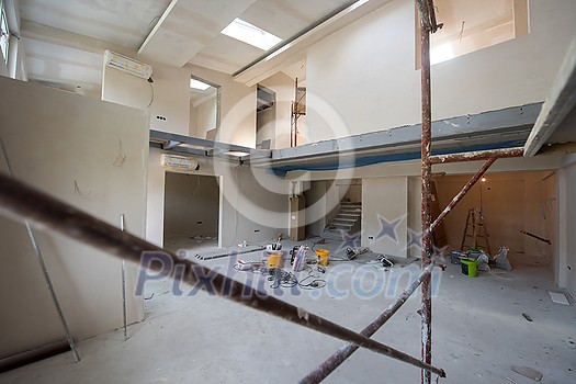 interior of construction site with scaffolding in a large modern unfinished duplex apartment interior of construction site with scaffolding in a large modern unfinished duplex apartment