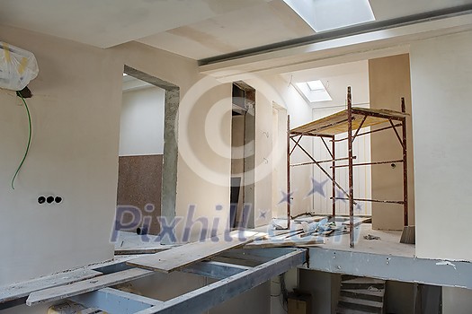 interior of construction site with scaffolding in a large modern unfinished duplex apartment