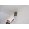 young professional construction worker plastering on gypsum walls inside the new big modern two levels apartment