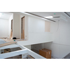 Interior of unfinished stylish modern open space two level apartment with white walls soon ready to move in