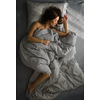 Pretty, young woman in her bed, fast asleep. Importance of sleep concept
