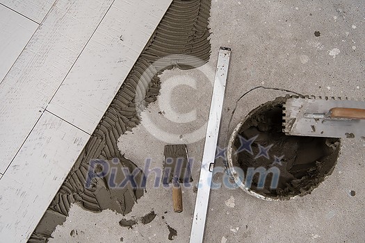 Ceramic wood effect tiles and tools for tiler on the floor unfinished laying floor tiles Floor tiles installation Ceramic wood effect tiles and tools for tiler on the floor unfinished laying floor tiles Floor tiles installation