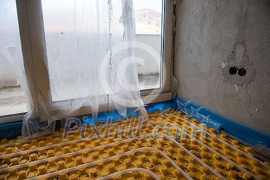 yellow underfloor heating installation with white polyethylene pipes on construction site of new two level apartment yellow underfloor heating installation with white polyethylene pipes on construction site of new two level apartment