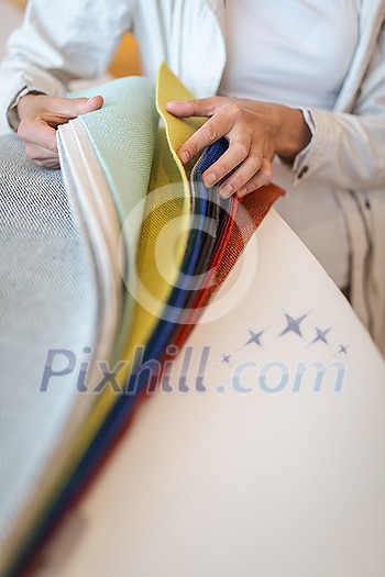 Pretty young woman choosing the right material/color for her modern appartement interior (shallow DOF; color toned image) Pretty young woman choosing the right material/color for her modern appartement interior (shallow DOF; color toned image)