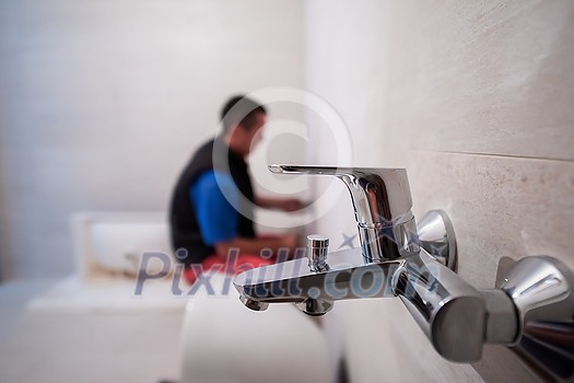 professional plumber working in a bathroom, plumbing repair service, assemble and install concept plumber tools and equipment in a bathroom professional plumber working in a bathroom, plumbing repair service, assemble and install concept plumber tools and equipment in a bathroom
