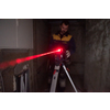 professional worker using laser level in a building under construction. Laser equipment at a construction site