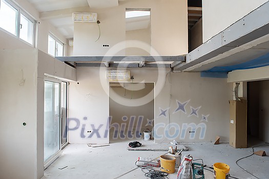 interior of construction site with scaffolding in a large modern unfinished duplex apartment