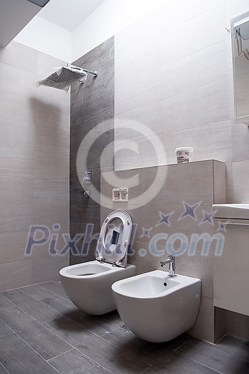 work in progress  luxury stylish unfinished bathroom interior with toilet,bidet sink fancy shower on the wall